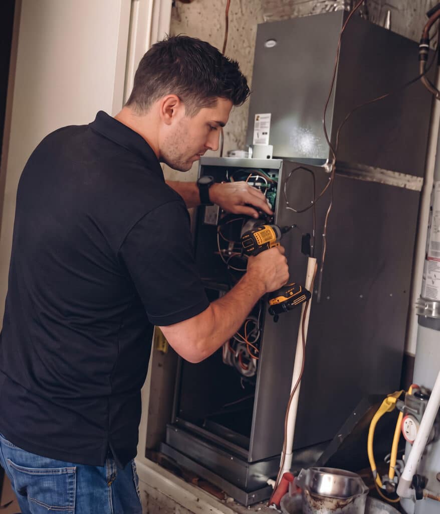 Next Level Heating & Air technician fixing furnace in Richmond, KY.